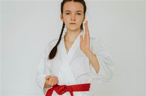 Red belt girl performing martial arts move